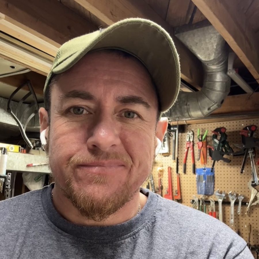 Portrait in a workshop with tools on a pegboard behind
